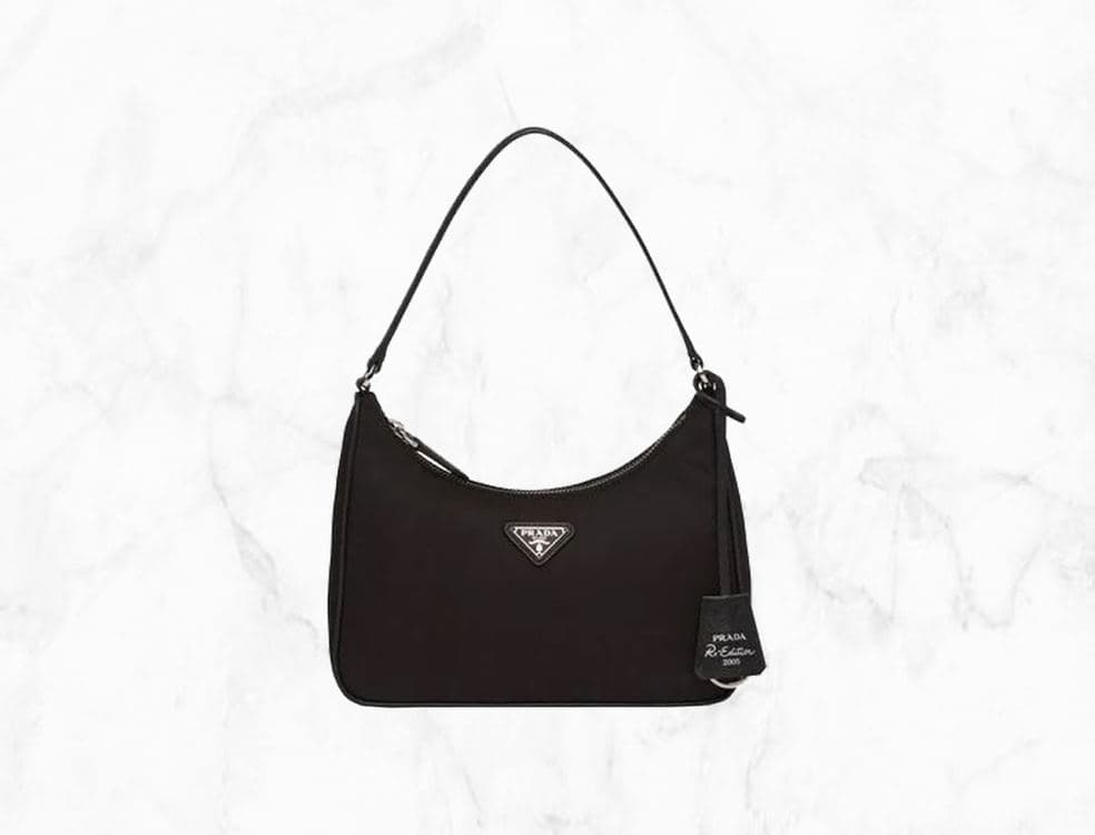 Black nylon Prada Re-Nylon Re-Edition 2000 shoulder bag on a white marble background