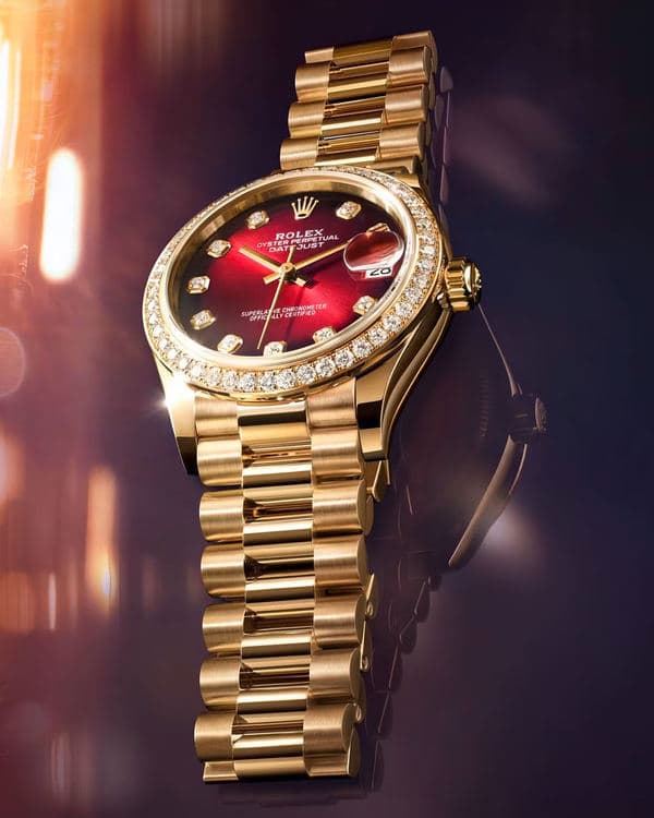 Gold-colour Rolex Datejust 31 watch with a red dial