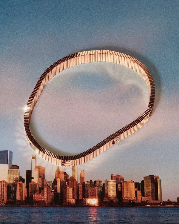 Rose-gold-toned Cartier Love Unlimited bracelet encircling a city skyline at dusk