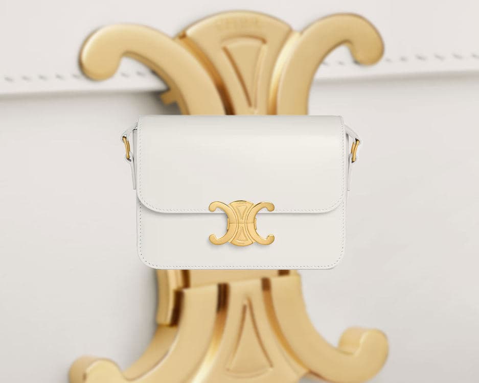 White CELINE Teen Triomphe centred against an oversized gold Triomphe emblem