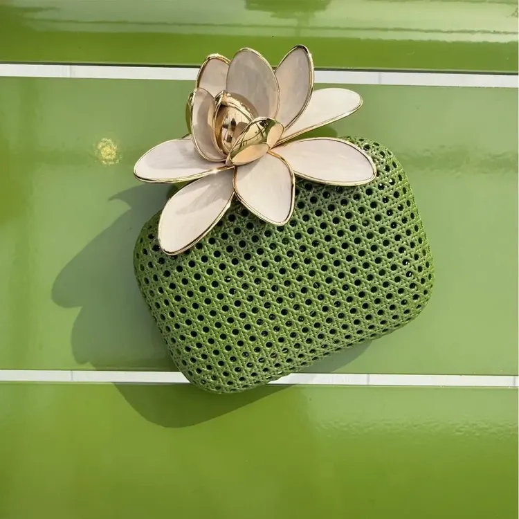 Green woven Dior pouch topped with large white petals