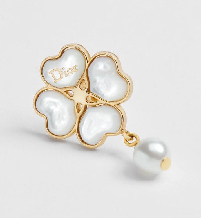Close-up of a Dior clover earring with a pearl drop