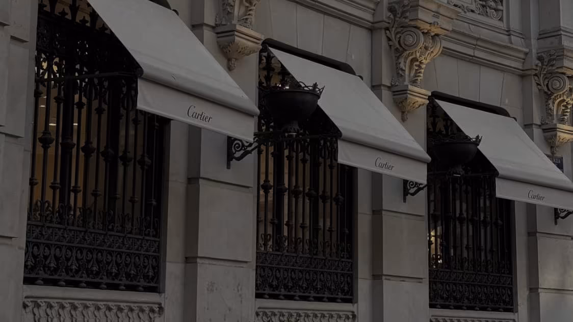 A row of canvas awnings along a luxury jewellery boutique facade