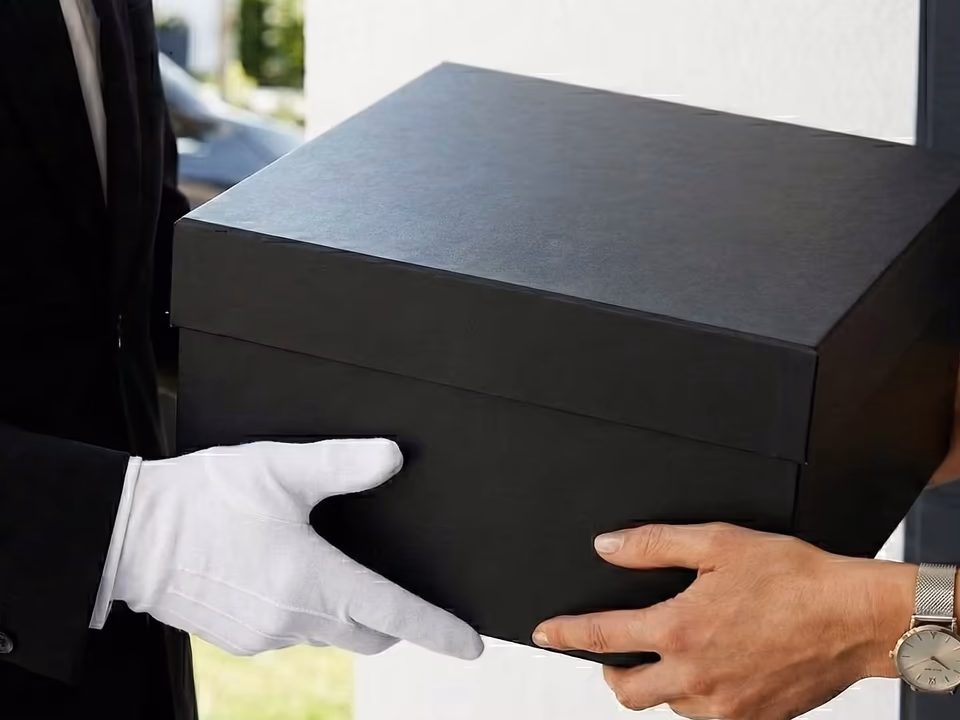 Handing a boxed item to a gloved staff member